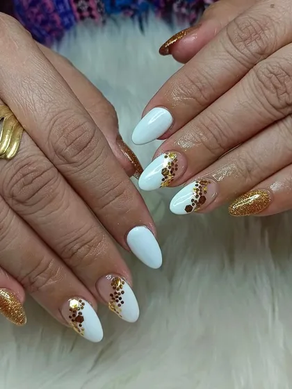 A chic and modern design with white nails and abstract gold glitter polka dots. This is a great way to add some sparkle while keeping the look sophisticated.