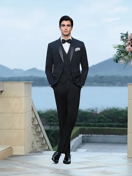 A three-piece patterned suit styled for a Louis Philippe campaign at Raffles Udaipur. The full-length shot showcases the sharp tailoring and fit, set against the serene backdrop of the lake to create a look of relaxed luxury.