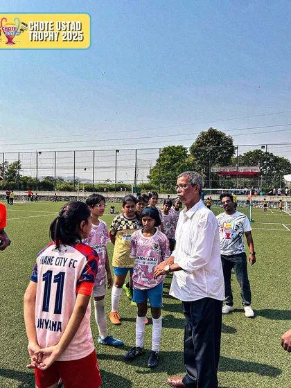 An official speaks to our girls' team before a game, highlighting the professional environment of the tournaments we participate in.