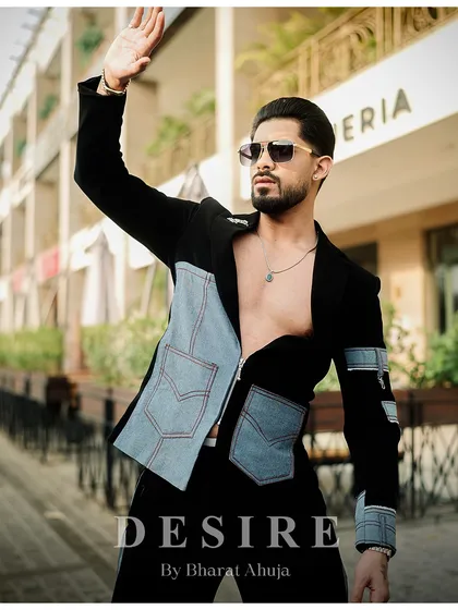 A dynamic pose that captures the energy of the black and denim fusion jacket. This is fashion for the man who is not afraid to make a statement.
