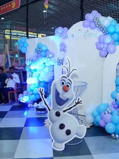 Another angle of the 'Frozen' party decor, showing how we use lighting and props like the Olaf cutout to create an immersive experience.