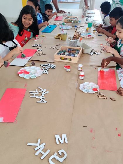 So much creative energy! A table full of children painting and designing their own nameplates during a fun birthday celebration.