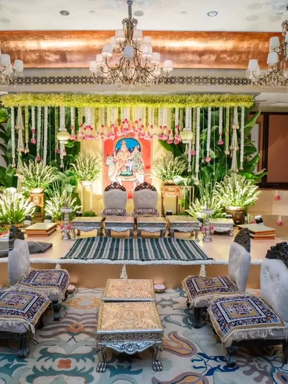 I have a deep appreciation for the sanctity of traditional ceremonies. This Muhurtham setup combines classic South Indian elements, like intricate floral arrangements and traditional seating, with a backdrop of a Ganesha painting, creating a space that is both divine and deeply personal.