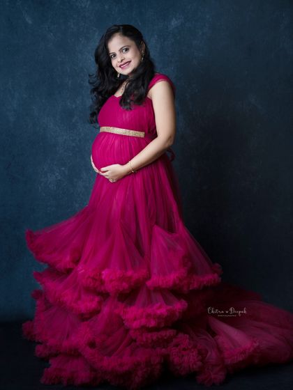 A joyful portrait in a magenta gown. The twirl of the dress adds a sense of happiness and movement to this beautiful shot.