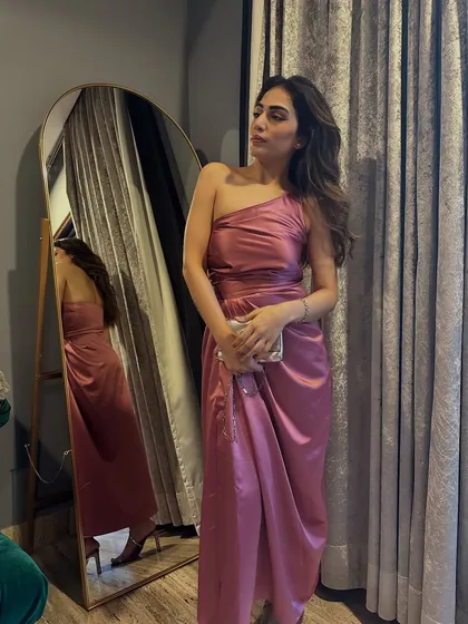 A mirror selfie of the pink satin dress, showing how it drapes on the body. The asymmetrical design is incredibly flattering.