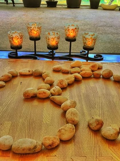A closer look at the 'Om' arrangement, with candles lit to create a serene atmosphere for our yoga sessions. The environment we create is an important part of preparing the mind and body for the practice.