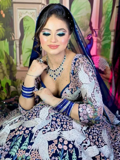 A softer, more serene pose. The eye makeup is the star of the show, with a beautiful blend of blue, silver, and black.