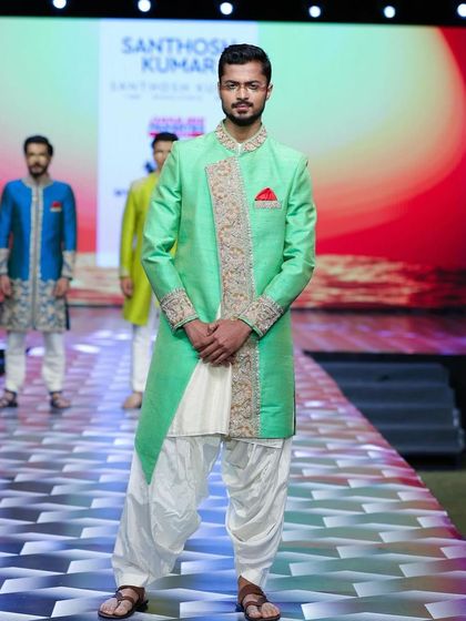 Showcasing a mint green ethnic piece on the runway, demonstrating the collection's range.