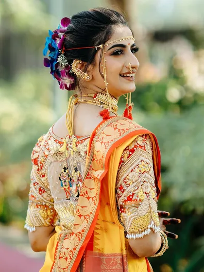 A portrait of a radiant Maharashtrian 'navri'. We focused on the exquisite details of her custom blouse and the genuine smile that lights up her face, creating a timeless memory of her special day.