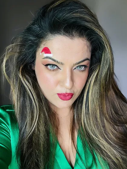 Feeling festive with this Christmas-themed makeup. The drawn-on Santa hat is a fun alternative to a real one, especially when you've spent time on your hair.