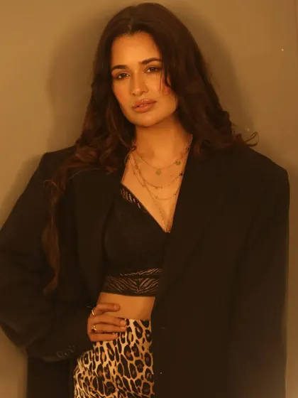 This shot highlights the layered necklaces and styling, with the makeup providing a clean and polished canvas. The look is chic and modern, with a timeless quality.