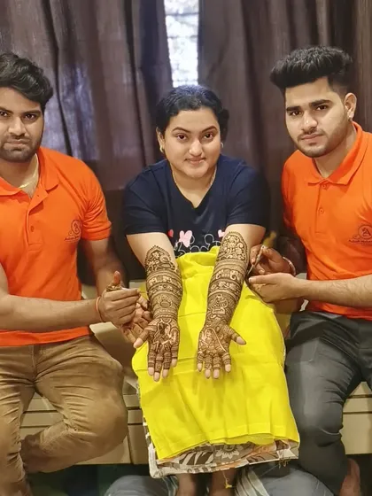 Our team is ready to serve you. Here are two of our artists with a client, showcasing the beautiful results of their teamwork.