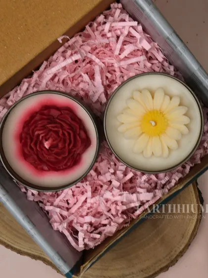 A gift set featuring two of my floral tin candles, a red rose and a white daisy, nestled in a box.