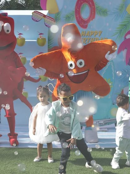 The birthday boy dancing with sea creature mascots amidst a flurry of bubbles. This photo perfectly captures the multi-layered entertainment I provide.