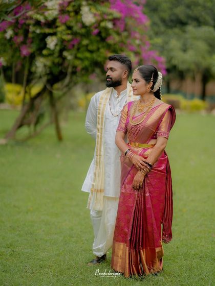 A poised and elegant portrait of the couple in a garden. This shot has a classic, timeless quality, showcasing their grace and style.