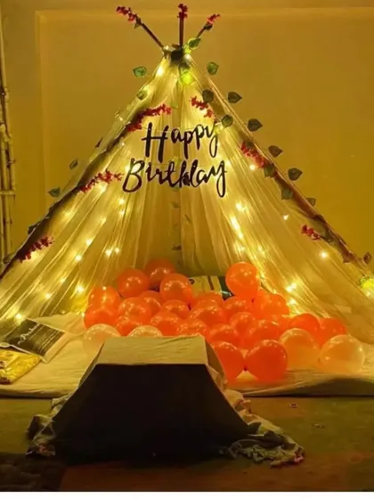 A duplicate of the birthday teepee tent, showing the warm and inviting setup with fairy lights and balloons.