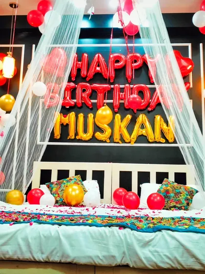 A straight-on view of the bed, showcasing the personalized name balloons and the romantic canopy. I can customize the name and colors for your special person.