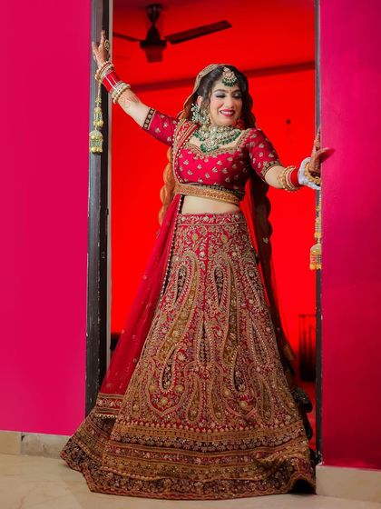 A joyful bride making her entrance, framed by a brightly colored doorway.