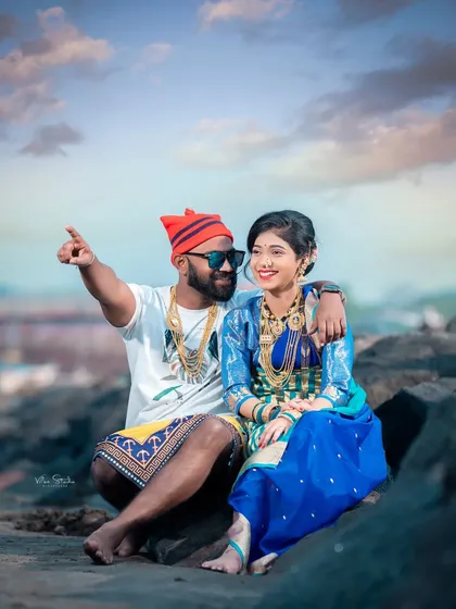A candid moment of conversation and connection. The groom-to-be points out at the sea, sharing a moment with his partner during their Agri-Koli themed shoot.