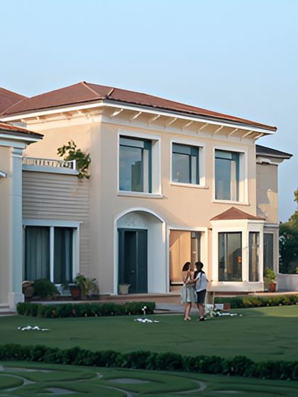 Expansive glass windows are framed by classic architectural moldings, creating a dialogue between modern openness and traditional elegance. The manicured lawn adds to the sense of a grand, welcoming estate.