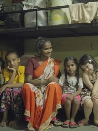 My daughter Ana sitting with a family at a night shelter. In this moment, she connected with children from a completely different walk of life. These experiences are crucial for building empathy and understanding the real-world impact of poverty and homelessness.