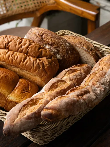 A basket filled with an assortment of my freshly baked breads. From crusty baguettes to soft loaves, each one is made with care and serves as the foundation for my sandwiches and toasts.