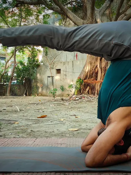 This is Urdhva Dandasana, the Upward Facing Staff Pose, often practiced as part of a headstand sequence. It builds core, neck, and shoulder strength while improving balance and circulation to the brain.