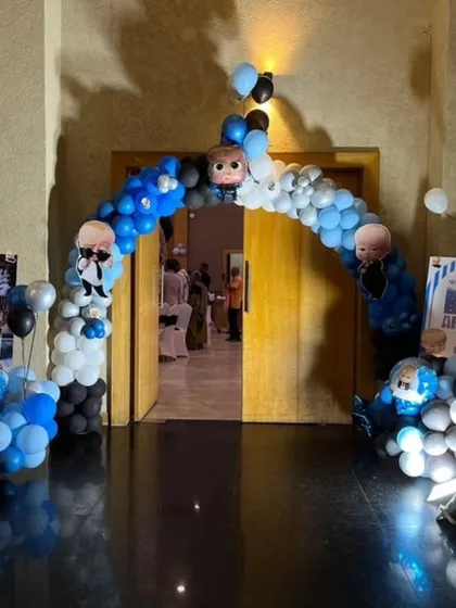 A Boss Baby themed balloon arch at the entrance of the party hall. The arch is decorated with character cutouts, welcoming guests to the celebration in style.