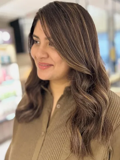 We transformed her hair from auburn red to a beautiful caramel beige balayage. I added face-framing layers to soften the look and highlight her features.