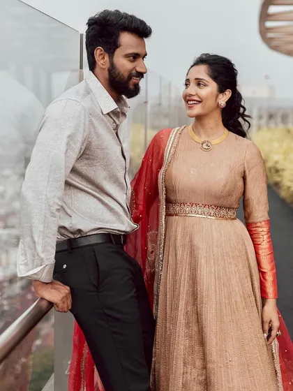 A candid moment between Milana Nagaraj and her partner, with her looking beautiful in our beige and red Anarkali set.