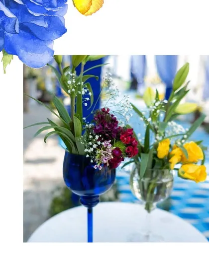 Even the smallest details matter. We used blue-tinted glassware for the floral arrangements to perfectly match the Blue Pottery wedding theme.