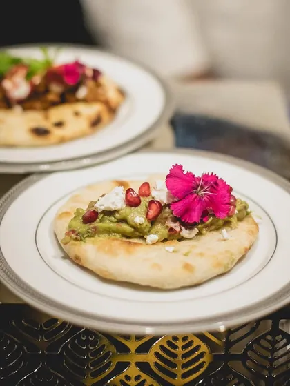 A modern take on a flatbread, topped with fresh guacamole, feta, and pomegranate seeds. The vibrant colours and fresh ingredients make this a popular choice for any event.