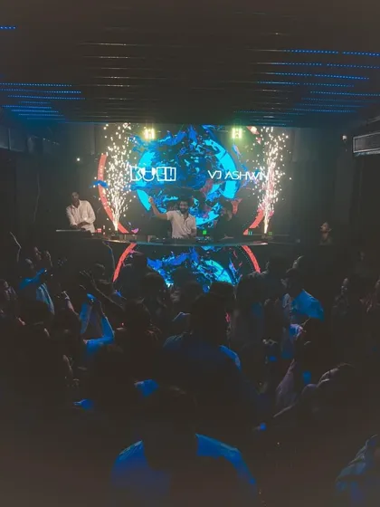 A wide shot of the party in full swing at Cavalry The Lounge. You can see the packed floor, the impressive LED screen, and the cold pyro effects creating a spectacular moment.