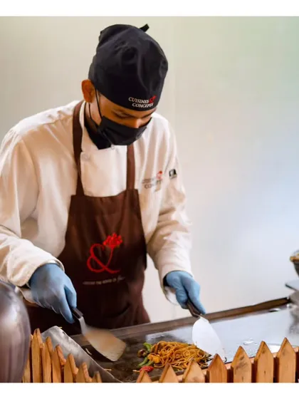 A chef prepares noodles at a live Asian station during a day reception. Our live stations are perfect for any time of day, bringing energy and fresh flavours to brunches, lunches, and dinners.