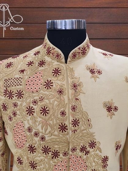 The royalty of this sherwani speaks for itself. This is a detailed view of the asymmetrical floral embroidery, combining different threadwork techniques to create a truly unique piece.