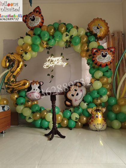 The full view of the 'Two Wild' jungle theme, showing the complete circular balloon arch and neon sign in a home setting.