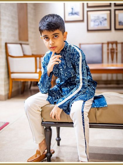 A full-length view of our client in the blue printed kurta, showing how it pairs perfectly with white pants for a clean, modern ethnic look.