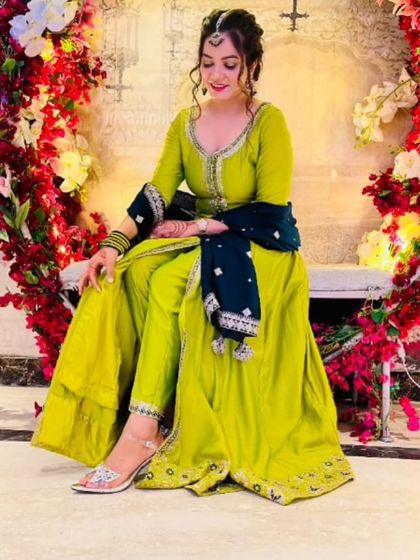 Perfect for a Haldi or Mehendi ceremony. This client is wearing a bright lime-green Anarkali suit, a comfortable and stylish rental alternative to a heavy lehenga.
