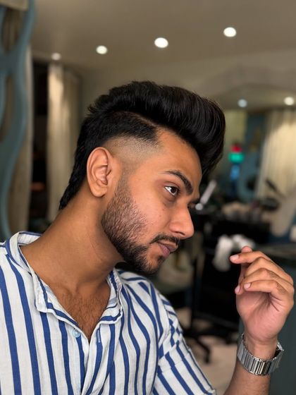 A fresh look for this client. This image shows a side profile of a textured top with a clean fade, a very popular men's haircut.