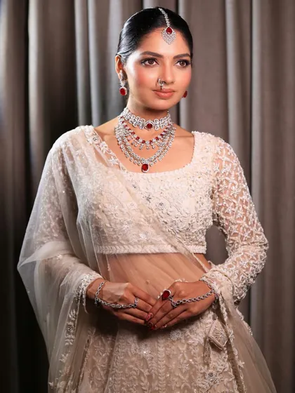A stunning portrait of the bride in her white lehenga, her makeup looking absolutely flawless. This is a perfect example of how to conquer the world with beauty.