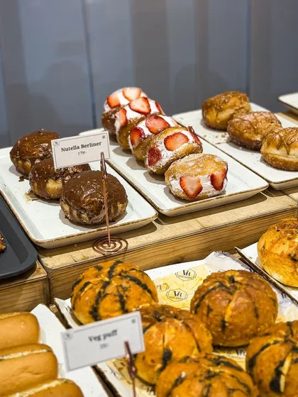 A glimpse of our daily counter lineup. You can see our fresh Berliners, savoury buns, and puffs ready for you. I love seeing the display full of fresh bakes each morning.