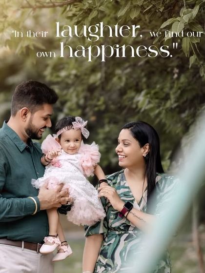 In their laughter, we find our own happiness. A candid and joyful family portrait taken in a lush, green outdoor setting.