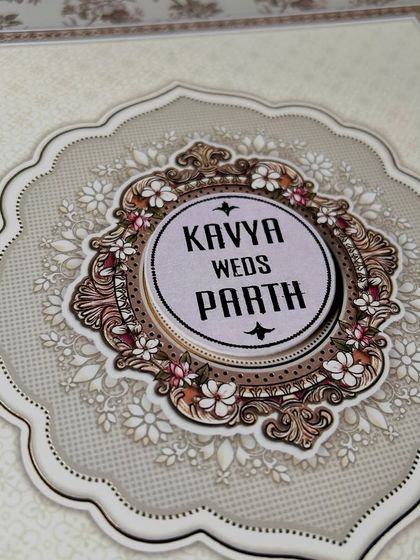 An intricate floral emblem designed to frame the couple's names. This style of custom logo adds a layer of sophistication and personalization to any wedding invitation.