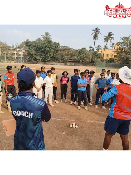 Coaches setting up a drill for a group of aspiring female cricketers during the trials.