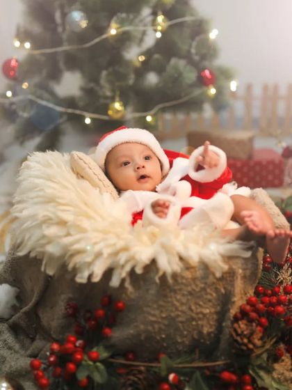 A little Santa looking up at the Christmas tree lights. Capturing their wonder and excitement is so special.