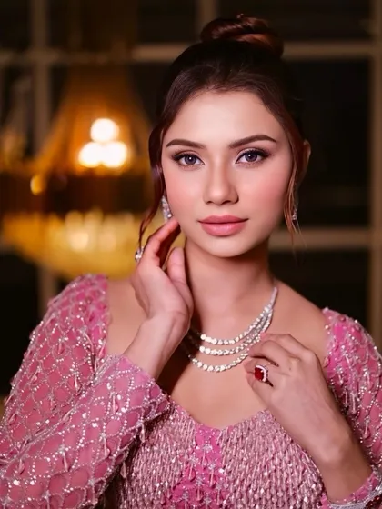 A stunning close-up of the final look. The pink eyeshadow, diamond jewellery, and elegant updo create a sophisticated and modern style.