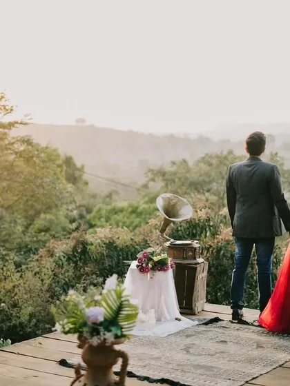 The couple holding hands and looking out at the stunning valley view, symbolizing the start of their new adventure together.