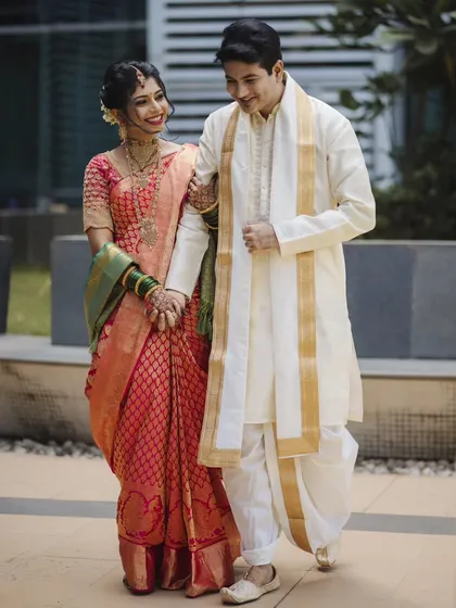 The couple takes a stroll, hand in hand. This candid-style portrait captures movement and their natural interaction, making the photograph feel alive and authentic.