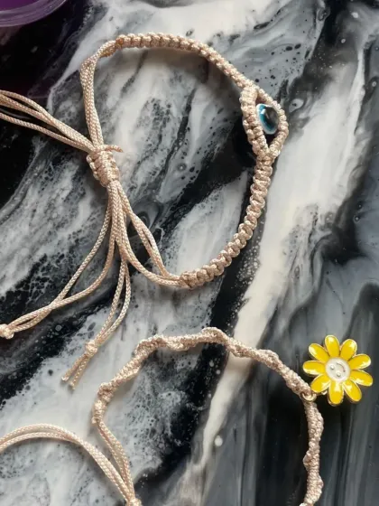 A view of both the evil eye and sunflower bracelets, showing how they can be worn together. These are part of my special Rakhi collection.