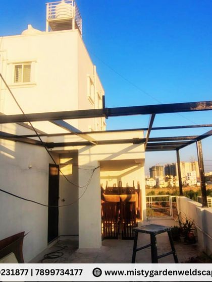 A view of the pergola framework from the terrace level. The structure is strategically positioned to maximize the usable outdoor space while providing shade and protection.